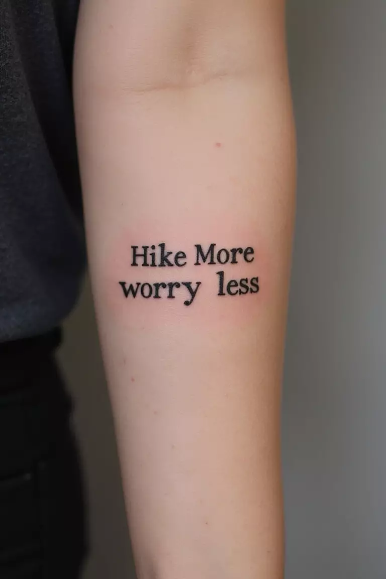 A close-up shot of a woman showing her black ink simple text 