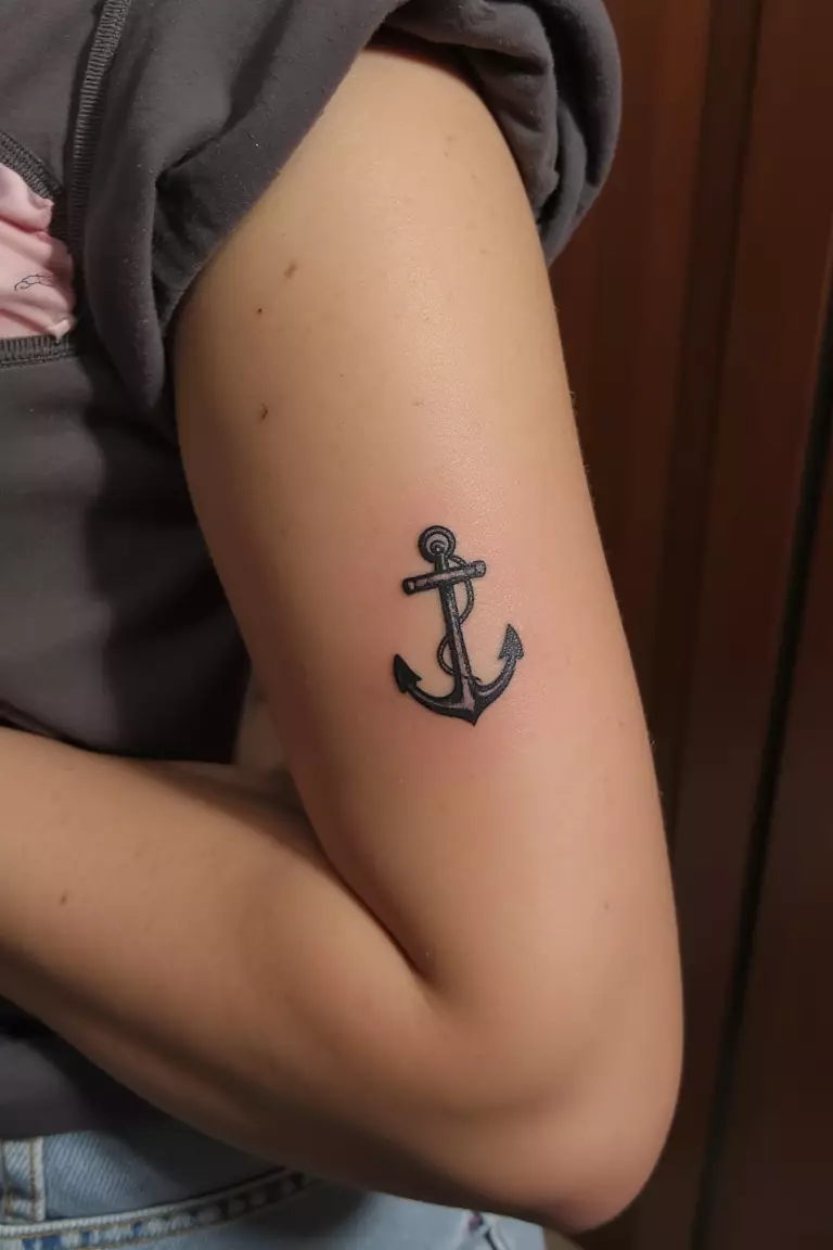 Small Anchor A close up shot of woman's arm with a black ink small anchor tattoo.