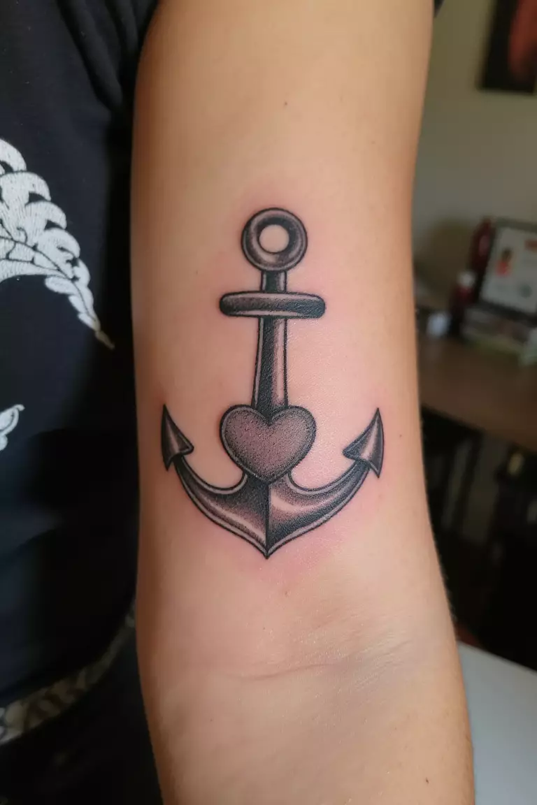 Anchor with Heart A close up shot of woman's arm with a black ink anchor with heart tattoo.