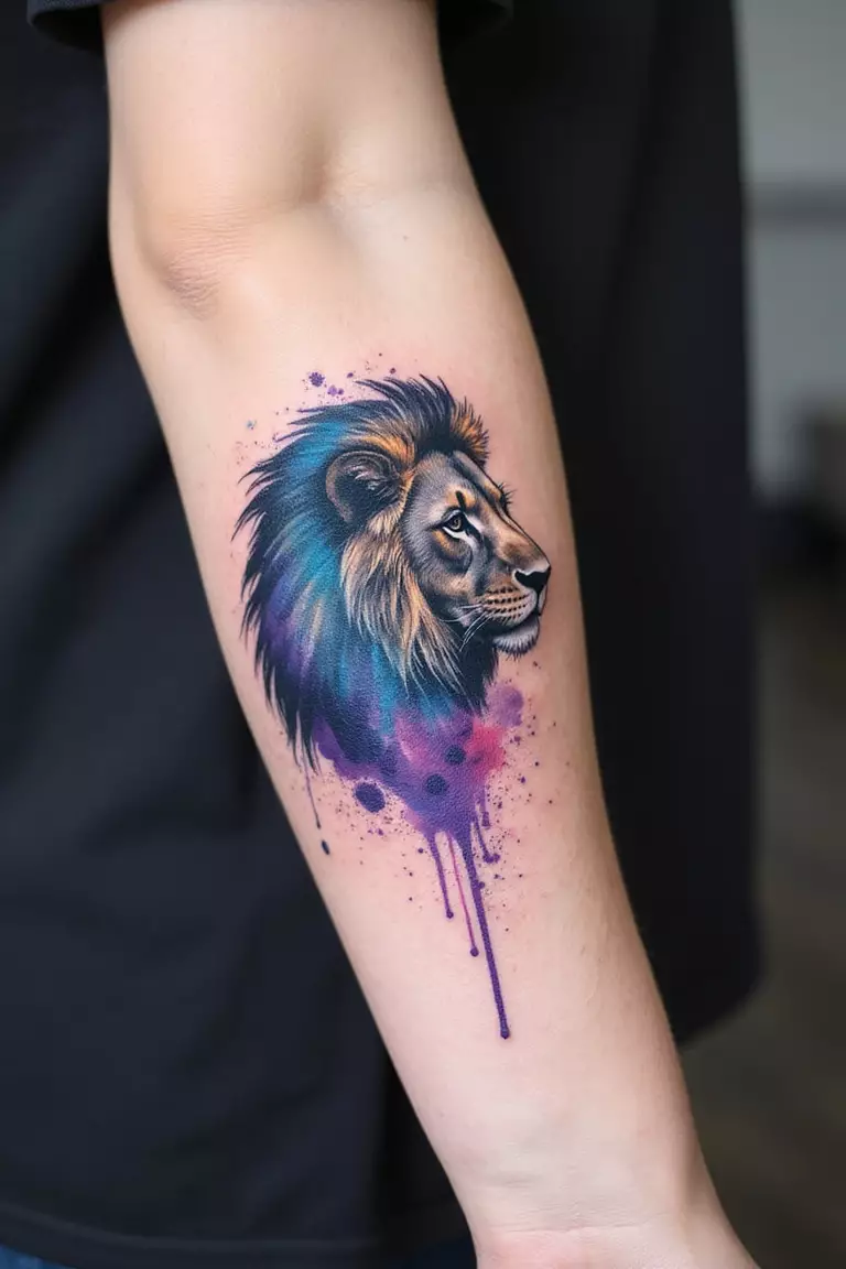 A close-up shot of a woman's arm with a black ink tattoo of a lion's silhouette filled with vibrant watercolor splashes in blue, purple, and pink.